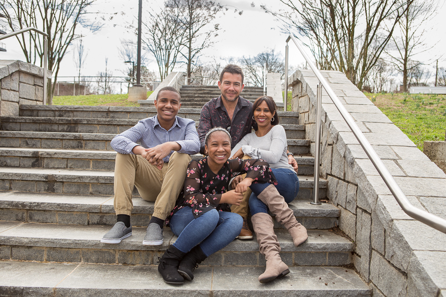 Family seated on steps for a family photo session in Atlanta, Georgia