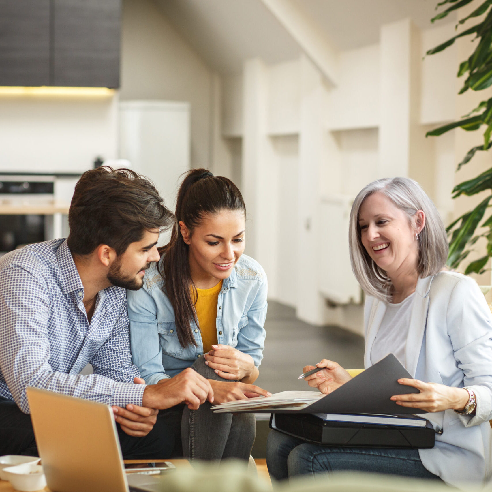 Photographer chats with two clients about their session.