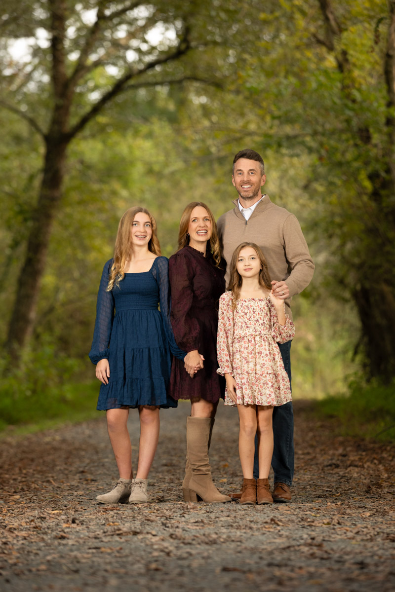 Photographer chats with two clients about their session.